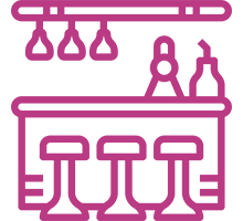 Bar counter icon with stools and glasses.