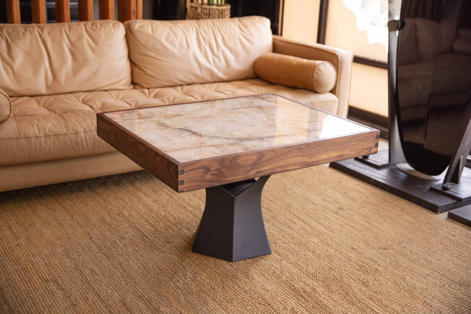 Modern square coffee table with a marble top and wooden frame.