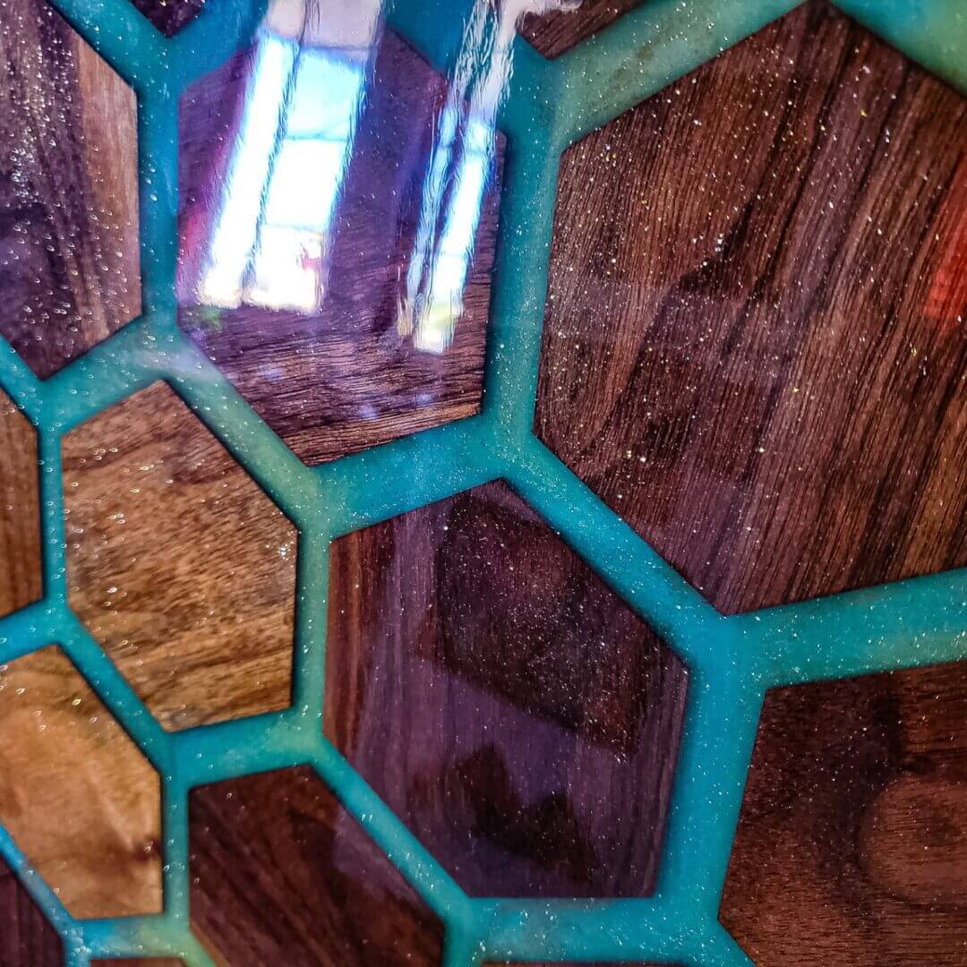 Close-up of a wooden honeycomb pattern with turquoise borders.