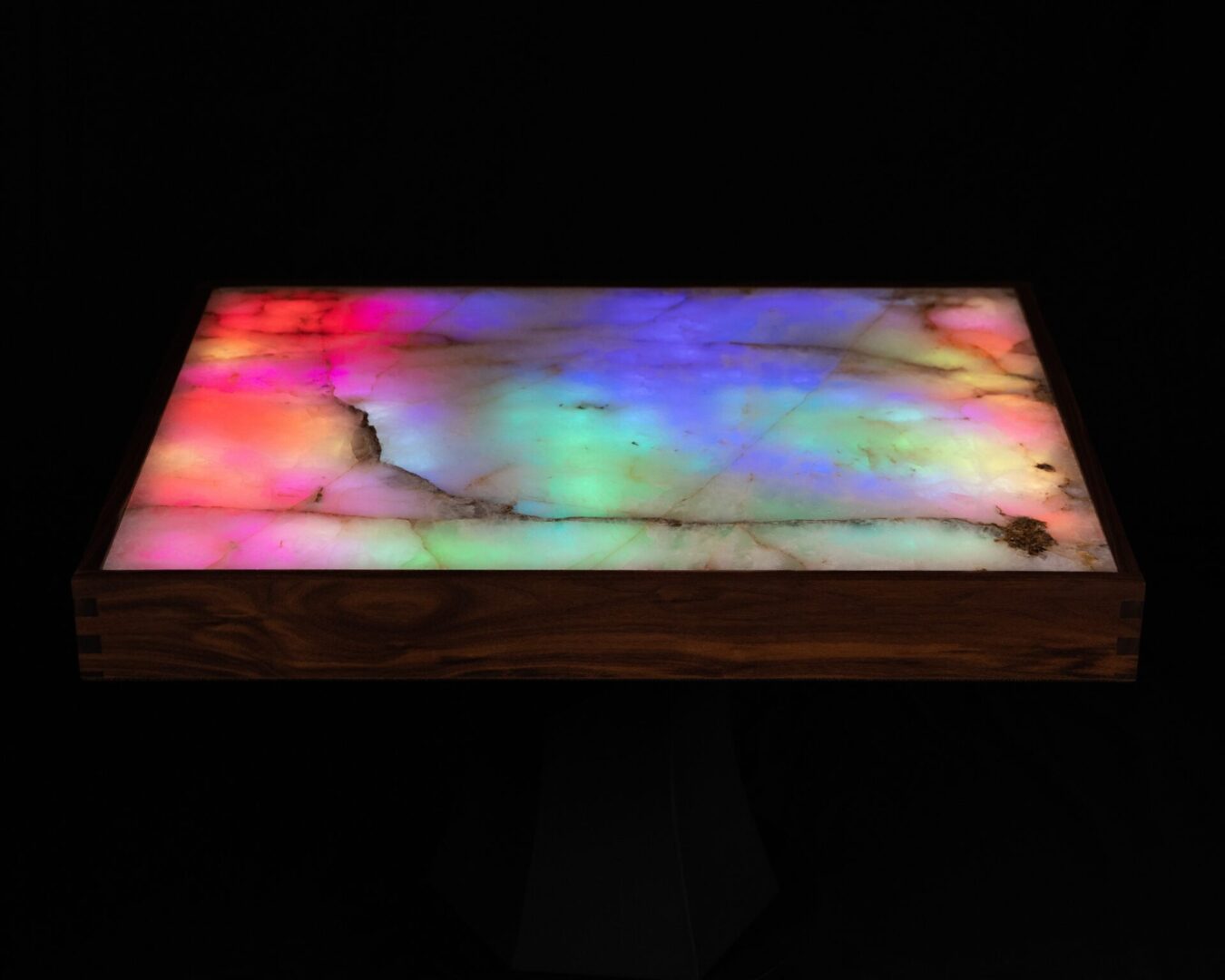 Colorful backlit onyx slab with a wooden frame.